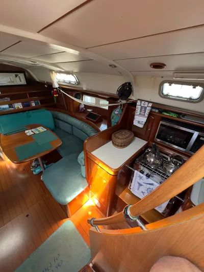  Yacht Photos Pics Interior of a 2000 Beneteau 411 sailboat with dining area and kitchen.