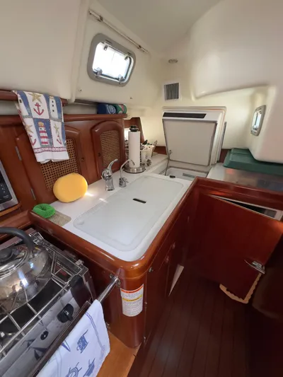  Yacht Photos Pics Interior of 2000 Beneteau 411 sailboat kitchen with sink, stove, and storage.