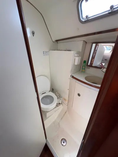  Yacht Photos Pics 2000 Beneteau 411 yacht bathroom with toilet, sink, and mirror.