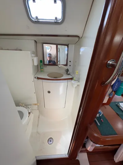  Yacht Photos Pics Beneteau 411 2000 yacht bathroom with sink, mirror, and toilet.