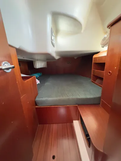  Yacht Photos Pics Cozy cabin interior of a 2000 Beneteau 411 sailboat with wooden furnishings.