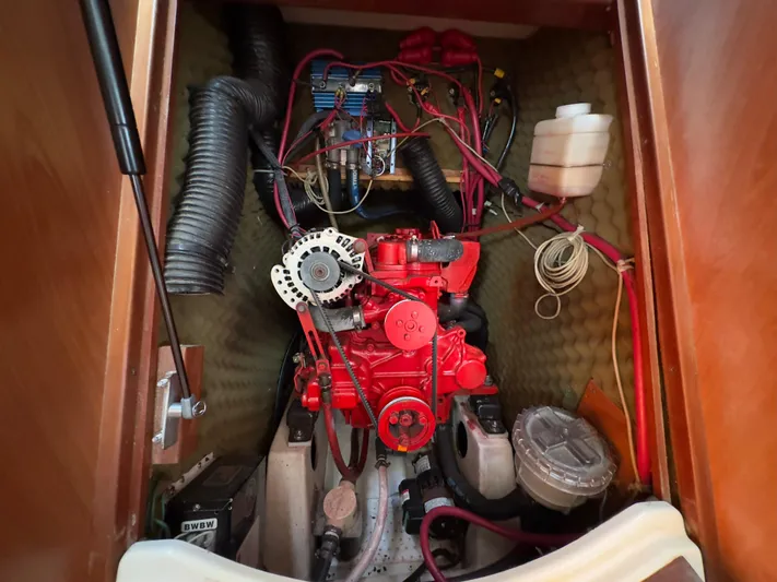  Yacht Photos Pics Engine compartment of a 2000 Beneteau 411 sailboat, showcasing mechanical components and wiring.