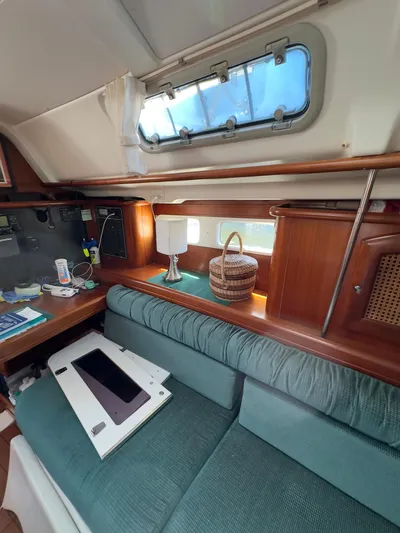  Yacht Photos Pics Interior of 2000 Beneteau 411 sailboat with cozy seating and wooden accents.