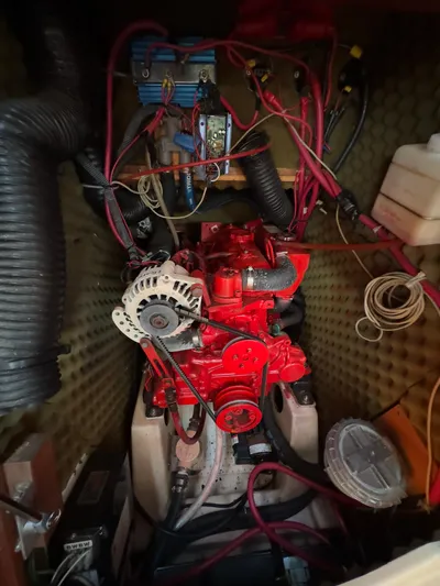  Yacht Photos Pics Engine compartment of a 2000 Beneteau 411 sailboat, featuring a red engine and wiring.