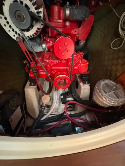  Yacht Photos Pics Engine compartment of a 2000 Beneteau 411 sailboat, featuring a red engine and wiring.