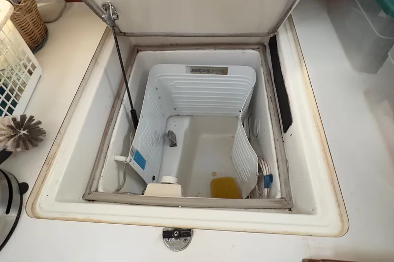  Yacht Photos Pics Beneteau 411 (2000) boat interior storage compartment with open lid, showcasing spacious design.