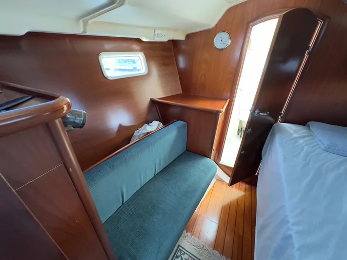 Yacht Photos Pics Interior of 2000 Beneteau 411 sailboat with wooden finish and cozy seating area.