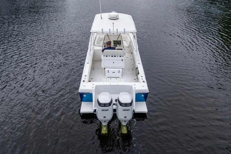  Yacht Photos Pics 2003 Intrepid 323 boat with dual 300 horsepower engines on calm water.