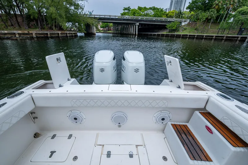  Yacht Photos Pics 2003 Intrepid 323 boat with dual Suzuki engines on a calm waterway.