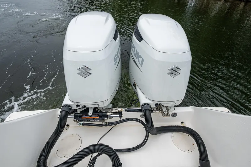  Yacht Photos Pics Twin Suzuki outboard motors on a 2003 Intrepid 323 boat in water.