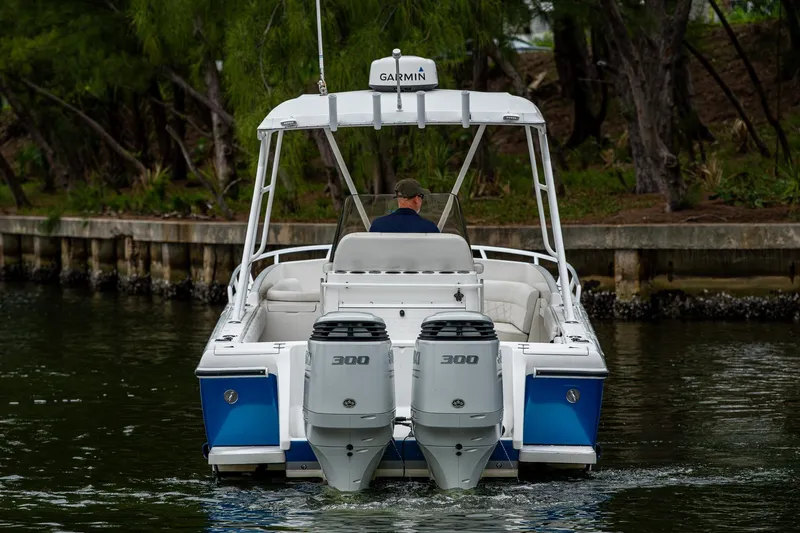  Yacht Photos Pics 2003 Intrepid 323 boat with twin 300 horsepower engines on a calm waterway.