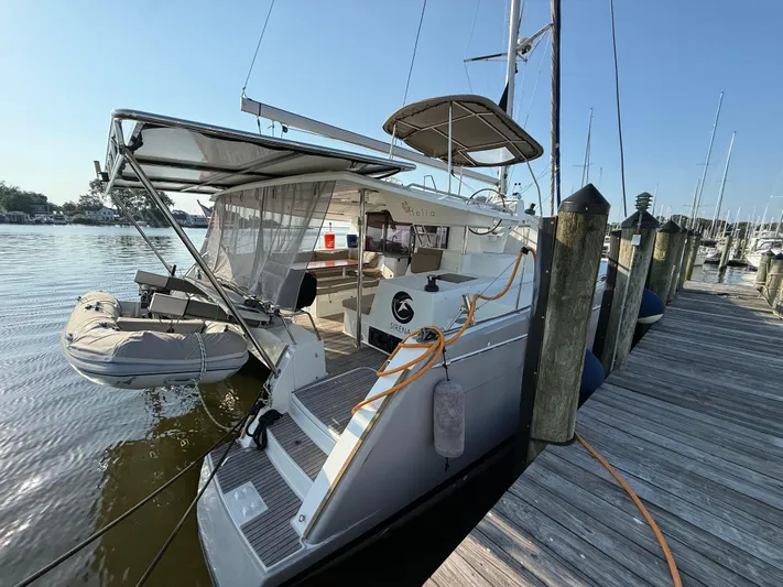 Sirena Yacht Photos Pics 2015 Fountaine Pajot Helia 44 catamaran docked with tender boat attached.