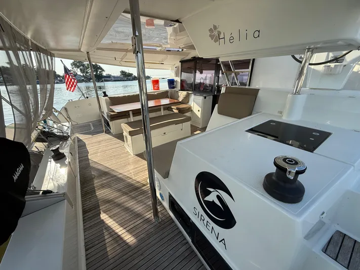 Sirena Yacht Photos Pics Spacious deck of 2015 Fountaine Pajot Helia 44 catamaran with seating and helm station.