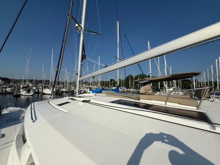 Sirena Yacht Photos Pics 2015 Fountaine Pajot Helia 44 catamaran docked in a marina under clear blue skies.