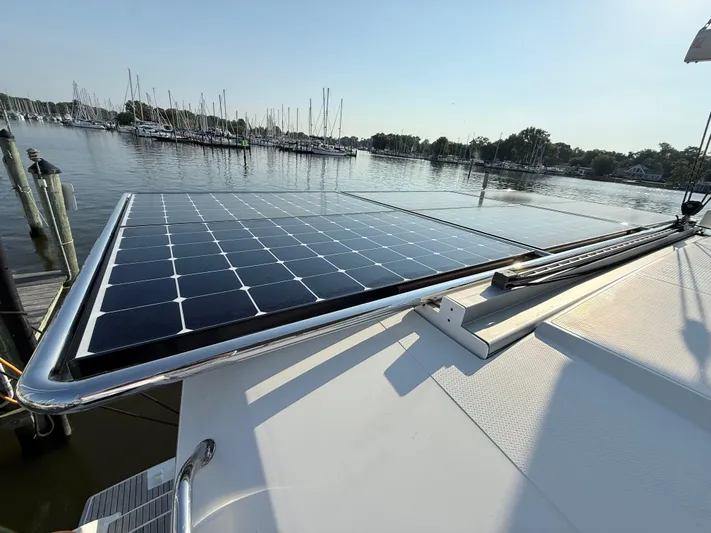 Sirena Yacht Photos Pics Solar panels on a 2015 Fountaine Pajot Helia 44 catamaran, docked at a marina.