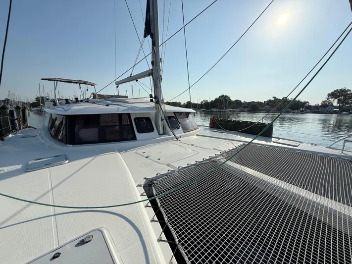 Sirena Yacht Photos Pics 2015 Fountaine Pajot Helia 44 catamaran docked in a serene marina setting.