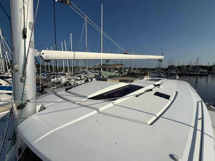 Sirena Yacht Photos Pics 2015 Fountaine Pajot Helia 44 catamaran docked at marina, clear sky background.