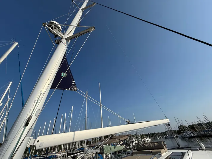 Sirena Yacht Photos Pics Sailboat mast and boom of 2015 Fountaine Pajot Helia 44 against clear blue sky.
