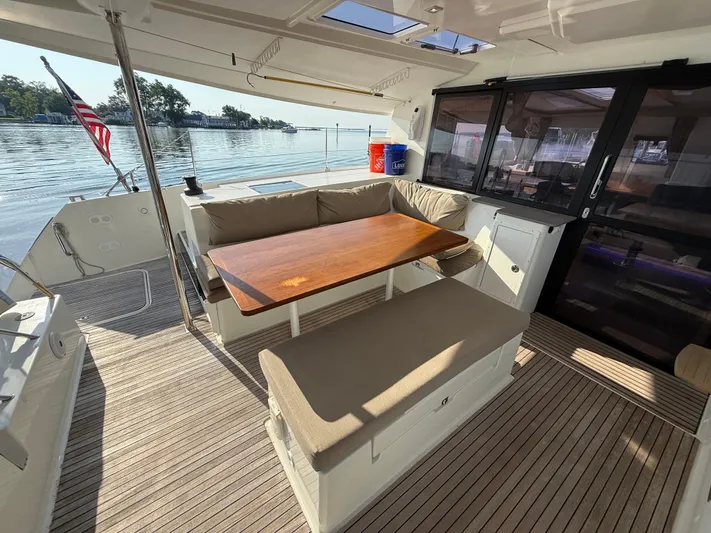 Sirena Yacht Photos Pics Spacious deck of 2015 Fountaine Pajot Helia 44 catamaran with seating and table.