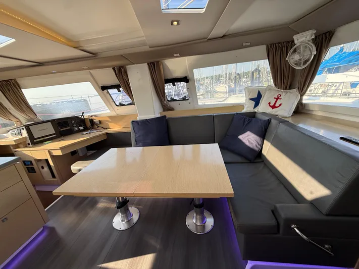 Sirena Yacht Photos Pics Luxurious interior of 2015 Fountaine Pajot Helia 44 catamaran with modern seating and navigation area.