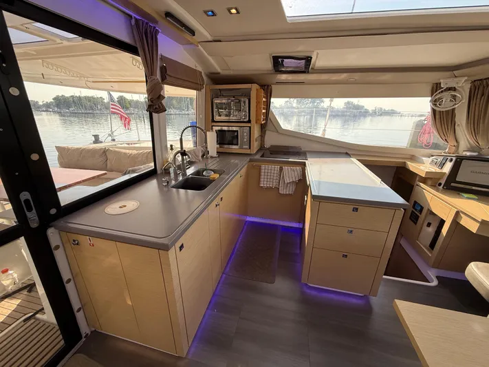 Sirena Yacht Photos Pics Modern kitchen interior of 2015 Fountaine Pajot Helia 44 catamaran with scenic water view.