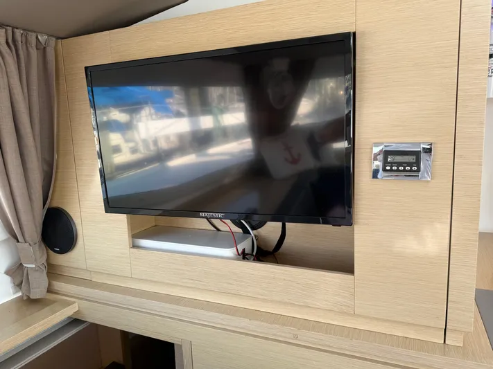 Sirena Yacht Photos Pics Interior of 2015 Fountaine Pajot Helia 44 with TV and control panel.