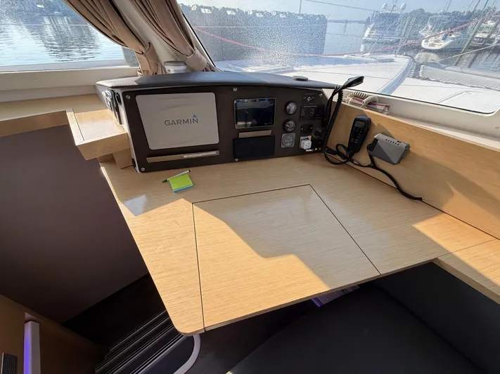 Sirena Yacht Photos Pics Navigation station on 2015 Fountaine Pajot Helia 44 catamaran with Garmin equipment and wooden desk.