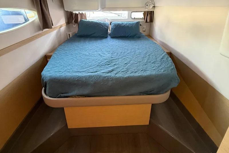 Sirena Yacht Photos Pics Cozy bedroom interior of 2015 Fountaine Pajot Helia 44 catamaran with blue bedding.