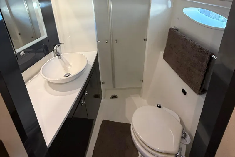 Sirena Yacht Photos Pics Bathroom interior of 2015 Fountaine Pajot Helia 44 catamaran, featuring sink and toilet.