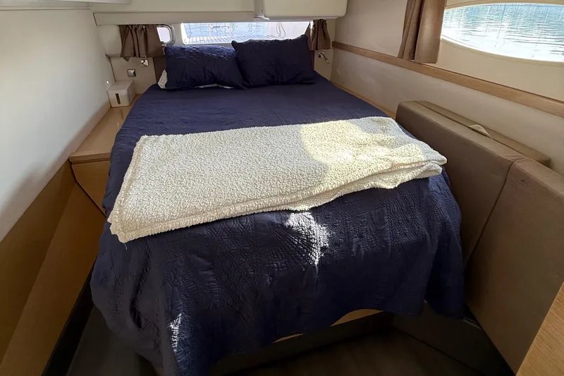 Sirena Yacht Photos Pics Cozy bedroom interior of 2015 Fountaine Pajot Helia 44 catamaran with plush bedding.