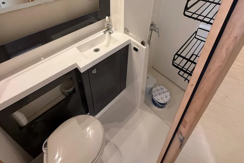 Sirena Yacht Photos Pics Bathroom interior of 2015 Fountaine Pajot Helia 44 catamaran, featuring sink and toilet.
