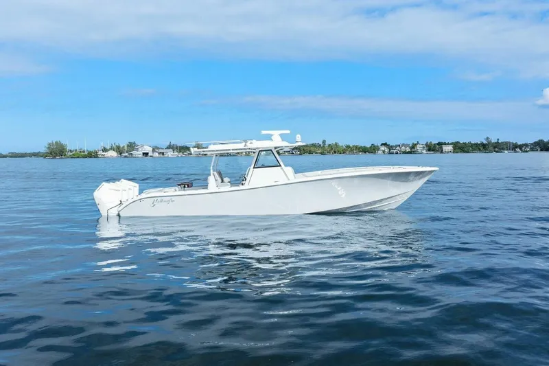  Yacht Photos Pics 2023 Yellowfin 39 Offshore boat on calm water under blue sky.