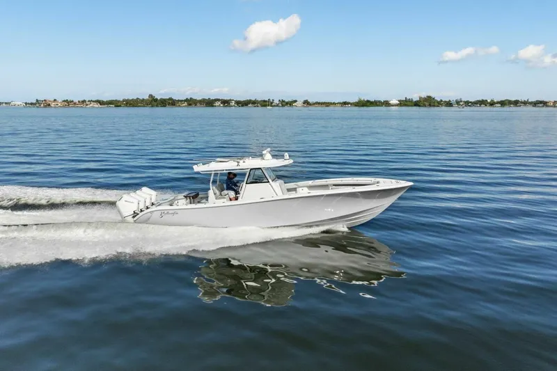  Yacht Photos Pics 2023 Yellowfin 39 Offshore boat cruising on calm waters under a clear blue sky.