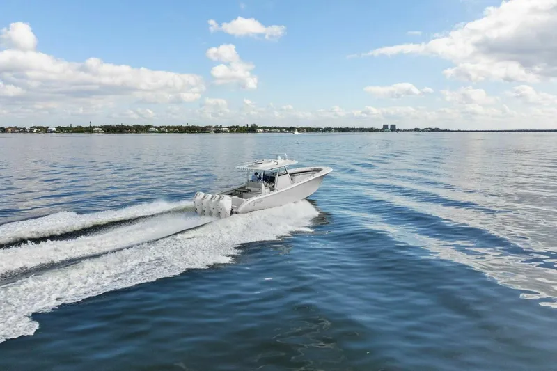  Yacht Photos Pics 2023 Yellowfin 39 Offshore boat cruising on calm waters under a blue sky.