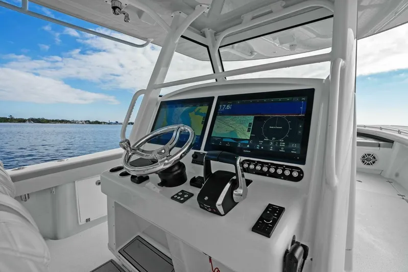  Yacht Photos Pics 2023 Yellowfin 39 Offshore boat cockpit with advanced navigation system and steering wheel.
