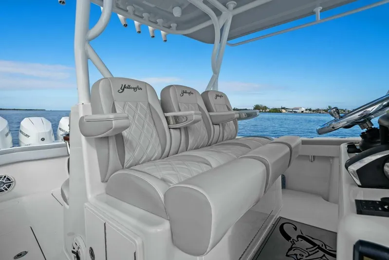  Yacht Photos Pics 2023 Yellowfin 39 Offshore boat interior with luxurious seating and steering wheel.