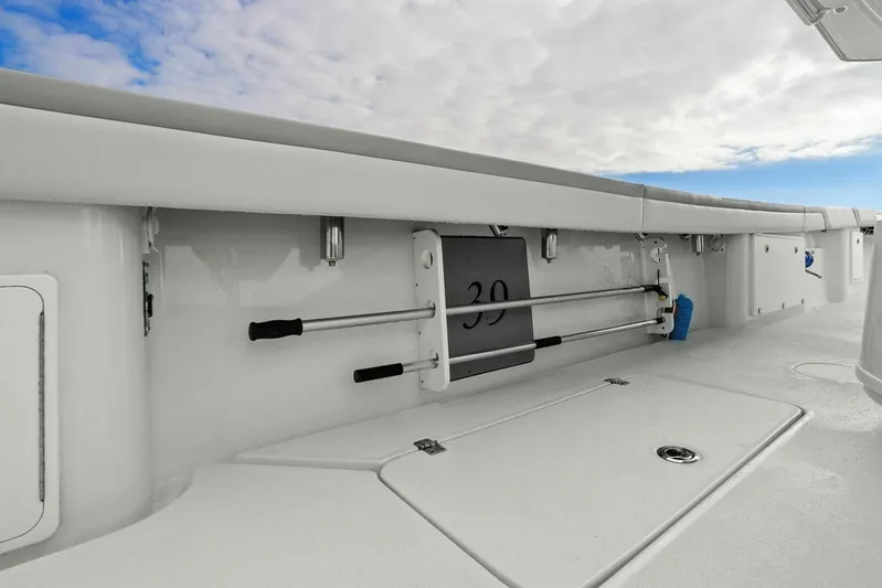  Yacht Photos Pics 2023 Yellowfin 39 Offshore boat deck with storage compartments and cleaning tools.