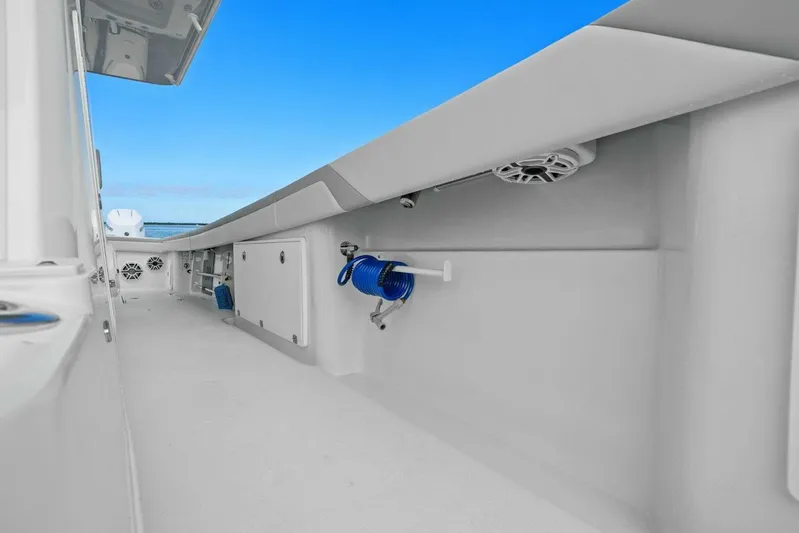  Yacht Photos Pics 2023 Yellowfin 39 Offshore boat interior with storage compartments and blue hose.