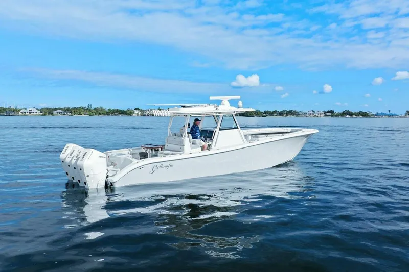  Yacht Photos Pics 2023 Yellowfin 39 Offshore boat cruising on calm waters under a clear blue sky.
