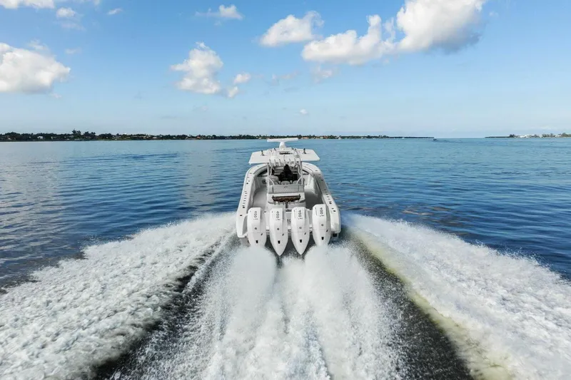  Yacht Photos Pics 2023 Yellowfin 39 Offshore boat cruising on open water, rear view.