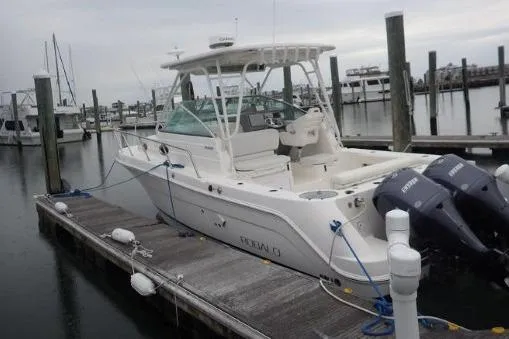  Yacht Photos Pics 2015 Robalo R305 Walkaround boat docked with twin engines, overcast sky.