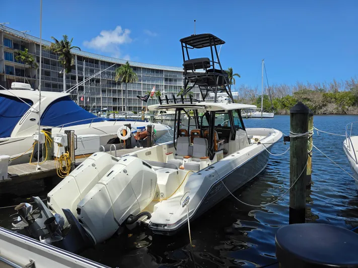 Grey Hawk Yacht Photos Pics 2023 Boston Whaler 360 Outrage docked at marina, clear blue sky background.