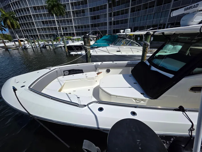 Grey Hawk Yacht Photos Pics 2023 Boston Whaler 360 Outrage docked at marina, showcasing sleek design and spacious deck.