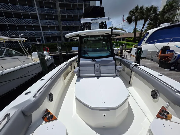 Grey Hawk Yacht Photos Pics 2023 Boston Whaler 360 Outrage boat docked, showcasing spacious seating and sleek design.