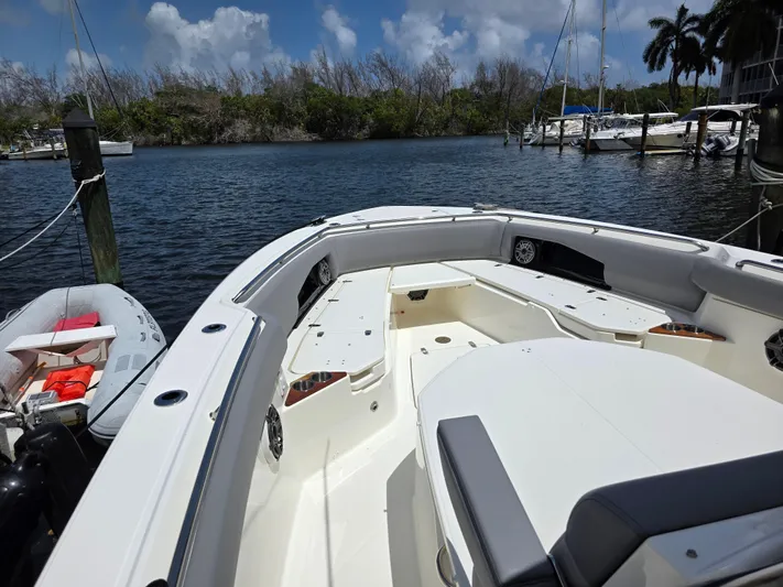 Grey Hawk Yacht Photos Pics 2023 Boston Whaler 360 Outrage boat docked in a serene marina setting.