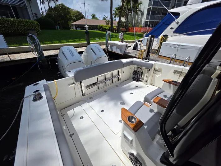 Grey Hawk Yacht Photos Pics 2023 Boston Whaler 360 Outrage boat interior with dual engines, docked at marina.