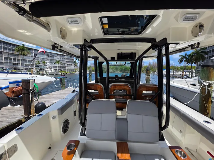 Grey Hawk Yacht Photos Pics 2023 Boston Whaler 360 Outrage interior, featuring sleek seating and modern design at a marina.
