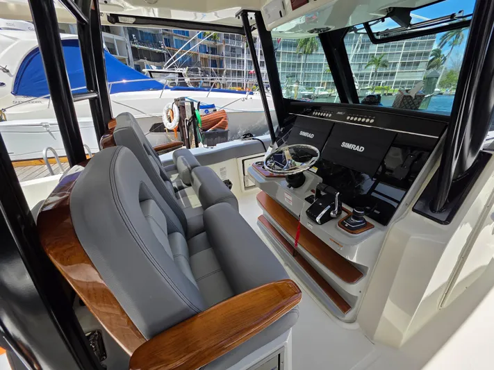 Grey Hawk Yacht Photos Pics 2023 Boston Whaler 360 Outrage helm with modern controls and luxurious seating.
