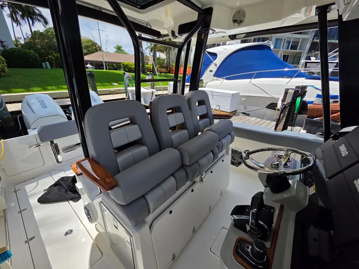 Grey Hawk Yacht Photos Pics 2023 Boston Whaler 360 Outrage interior with modern seating and steering console.