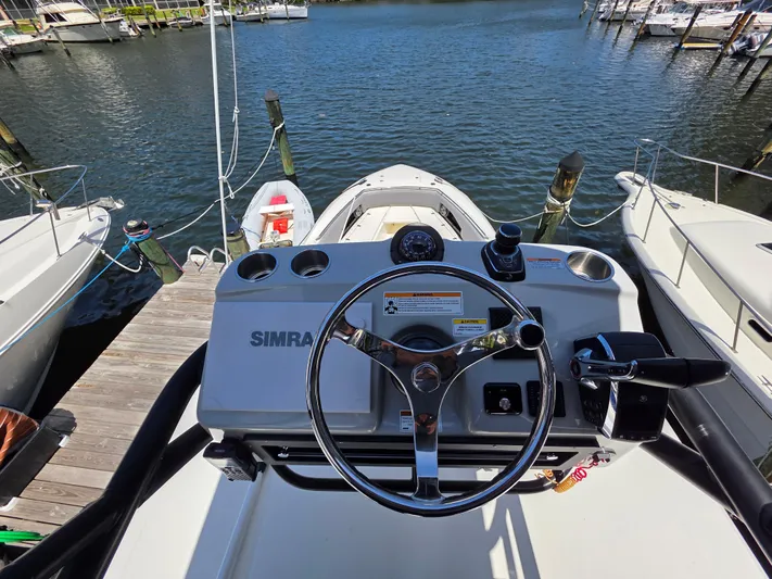 Grey Hawk Yacht Photos Pics Boston Whaler 360 Outrage 2023 helm with Simrad controls, docked at marina.